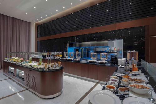 a buffet line with plates of food in a restaurant at Doubletree by Hilton Istanbul Umraniye in Istanbul