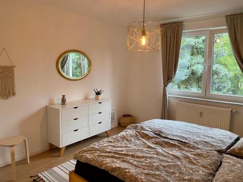 a bedroom with a bed and a mirror and a dresser at Ferienwohnung für Naturliebhaber in Peenemünde