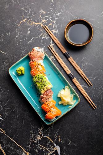 a plate of food with vegetables and chopsticks on a table at Hôtel Restaurant le Touring - Teritoria in Saint-Raphaël