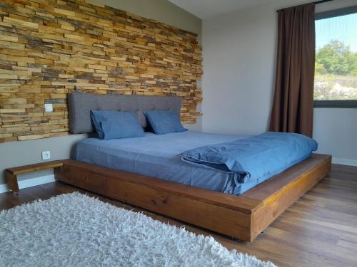 a bedroom with a bed with a brick wall at Müstakil Havuzlu Villa in Şile