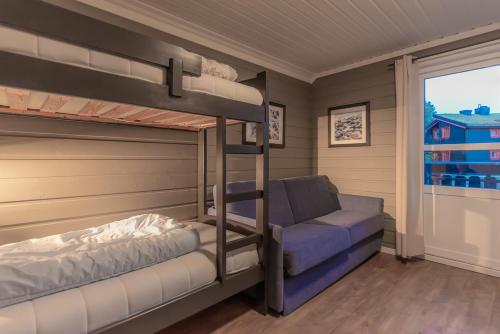 a bedroom with two bunk beds and a couch at Trysil Alpin 40A in Trysil