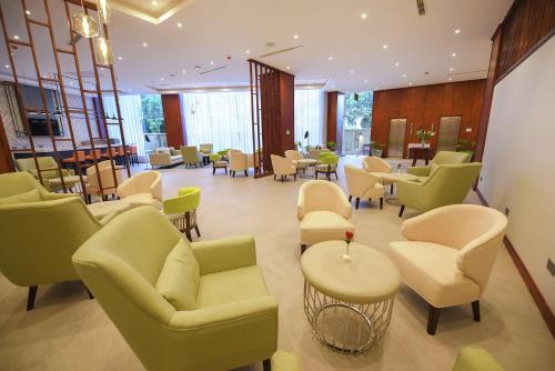 a waiting room with couches and tables and chairs at Hilton Garden Inn Kampala in Kampala