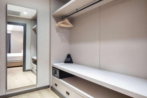 a walk in closet with a white counter and a mirror at Doubletree By Hilton Canakkale in Canakkale