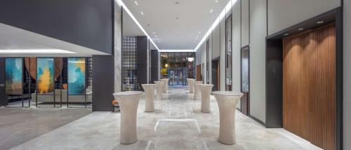 a hallway with a row of white stools in a building at Doubletree By Hilton Canakkale in Canakkale