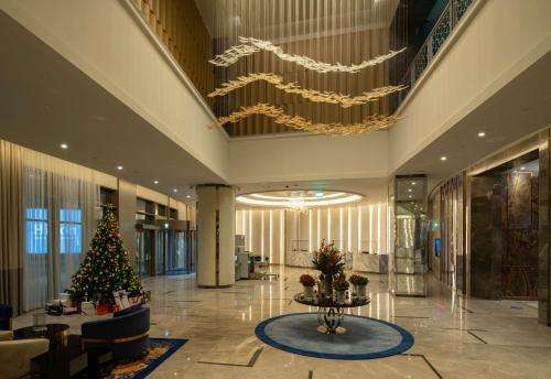 a large lobby with a christmas tree in the middle at Hilton Mall Of Istanbul in Istanbul
