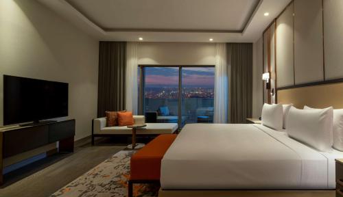 a hotel room with a bed and a television at Hilton Mall Of Istanbul in Istanbul