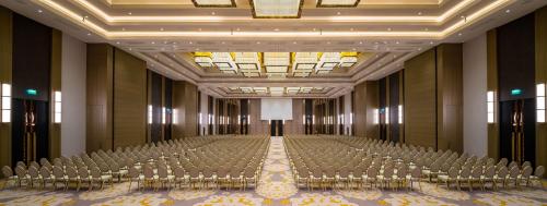an empty hall with rows of chairs and a stage at Hilton Mall Of Istanbul in Istanbul