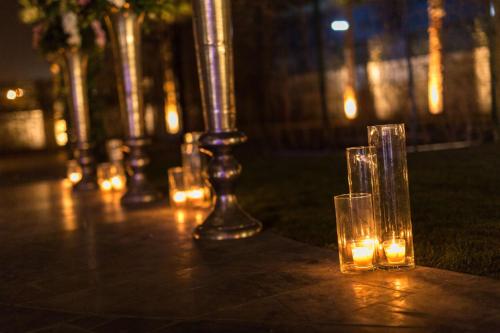 a group of glasses sitting on a table with lights at DoubleTree By Hilton Izmir Airport in Izmir