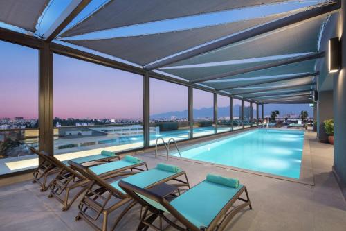 a swimming pool on the roof of a building at Doubletree By Hilton Antalya City Centre in Antalya