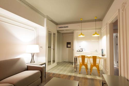 a living room with a couch and a table and chairs at DoubleTree By Hilton Izmir Airport in Izmir