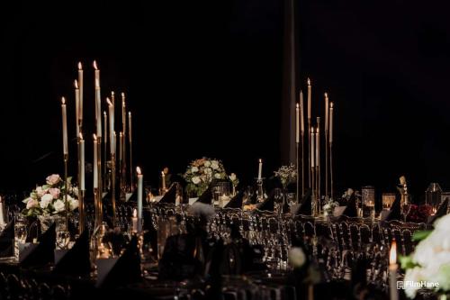 a long table with chandeliers and flowers at night at DoubleTree By Hilton Izmir Airport in Izmir