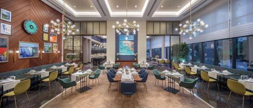 アンタルヤにあるDoubletree By Hilton Antalya City Centreのテーブルと椅子が備わるレストランの表示