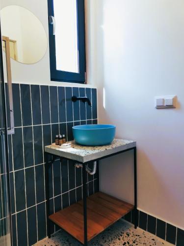 a bathroom with a blue sink on a counter at Pin Boutique Hotel in Dealu Frumos