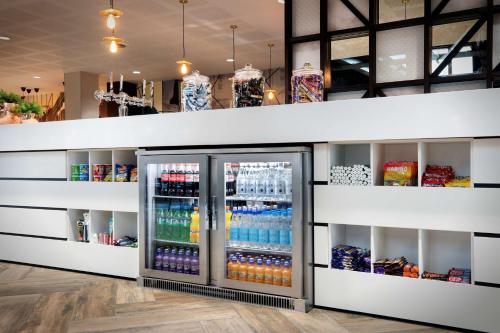 a drink refrigerator in a store with drinks at Hampton By Hilton Bristol Airport in Redhill