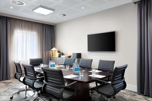 a conference room with a table and chairs at Hampton By Hilton Bristol Airport in Redhill