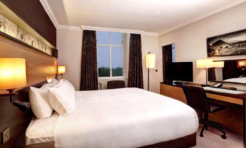 a hotel room with a bed and a desk and a computer at DoubleTree by Hilton Dunblane Hydro Hotel in Dunblane