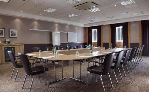 a conference room with a large table and chairs at DoubleTree by Hilton Dunblane Hydro Hotel in Dunblane