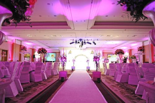 a room with white chairs and a aisle with purple lighting at DoubleTree by Hilton Dunblane Hydro Hotel in Dunblane