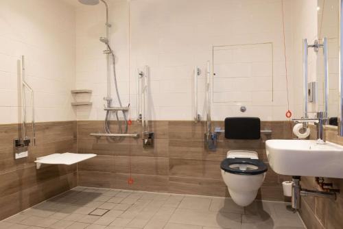 a bathroom with a toilet and a sink and a shower at Hilton Nottingham Hotel in Nottingham