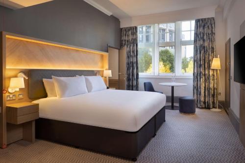 a hotel room with a large bed and a window at Hilton Nottingham Hotel in Nottingham