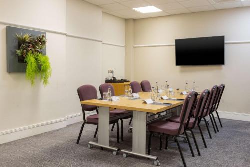 a conference room with a long table and chairs at Hilton Nottingham Hotel in Nottingham