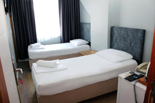 Ένα ή περισσότερα κρεβάτια σε δωμάτιο στο biglife hotel