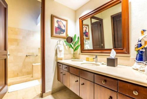 a bathroom with a sink and a shower and a mirror at Sunny Vacation Villa No 68 in San Rafael del Yuma
