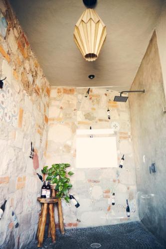a room with a window and a table with a plant at Casa Pavo Real en el Viñedo El Pavo Real del Campo in San Miguel de Allende