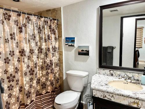 ein Badezimmer mit Toilette, Waschbecken und Spiegel in der Unterkunft Ocean Front PRINCESA Resort D108-Sandy Beach-Ground Floor-HUGE in Puerto Peñasco