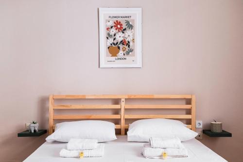 a bedroom with a bed with two pillows at The Easy in Thiseio next to ancient Athens in Athens