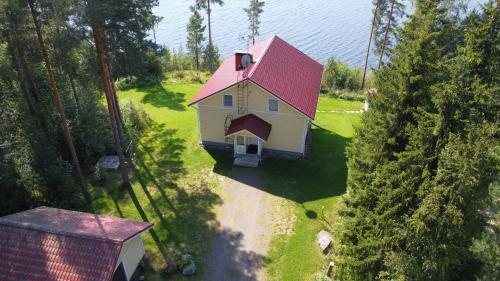 an aerial view of a house with a red roof at Jacuzzi Rantakallio in Melkoniemi