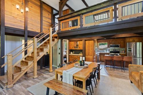 a dining room and kitchen with a staircase in a house at Banner Barn in Banner Elk