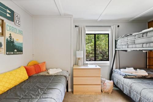 a bedroom with two beds and a bunk bed at Banner Barn in Banner Elk