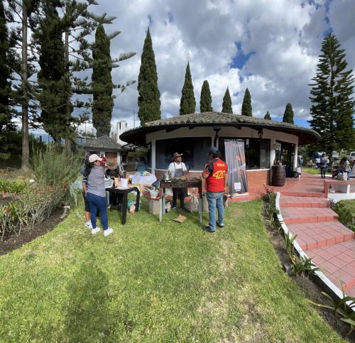 a group of people standing outside of a house at Quito Airport Suites Hotel in Tababela