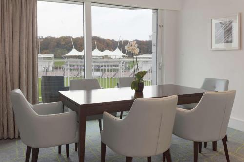 a dining room with a table and chairs and a window at Hilton Southampton - Utilita Bowl in Southampton