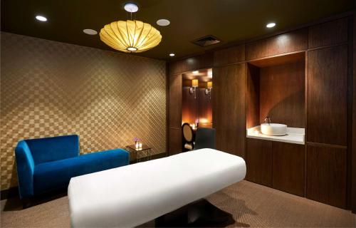 a bathroom with a couch and a blue chair at Hilton Southampton - Utilita Bowl in Southampton