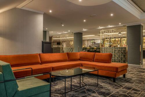 a living room with a couch and a table at Hilton London Watford in Watford