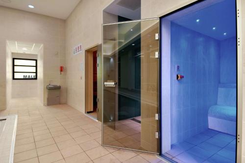 a glass shower door in a hallway in a building at Hilton Reading in Reading