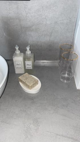 a bathroom with two bottles of soap and a sink at Newpark in Cobh