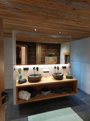 a bathroom with two sinks and a large mirror at Aignerhof in Flachau