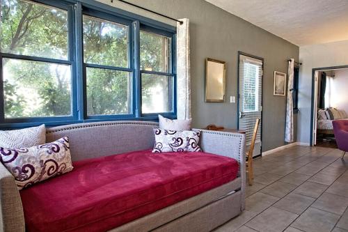 a bedroom with a couch with a red blanket at The Clarkdale Lodge in Clarkdale