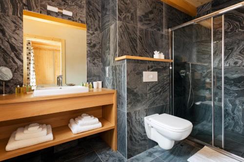 a bathroom with a sink and a toilet and a shower at Chalet Isabelle Mountain lodge 5 star 5 bedroom en suite sauna jacuzzi in Chamonix-Mont-Blanc