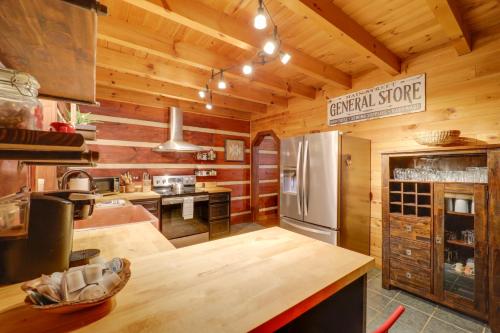 a kitchen with wooden walls and a refrigerator at Family-Friendly Blue Ridge Cabin with Game Room! in Fleetwood