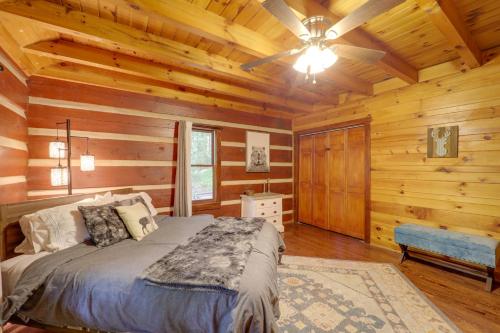 1 dormitorio con 1 cama y ventilador de techo en Gorgeous Log Cabin with 2 Decks and Fireplaces!, en Fleetwood