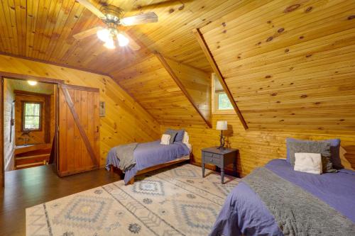 a bedroom with two beds in a log cabin at Family-Friendly Blue Ridge Cabin with Game Room! in Fleetwood