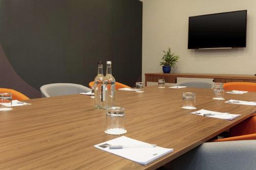 a conference room with a table with wine bottles on it at Hampton By Hilton Edinburgh Airport in Ingliston