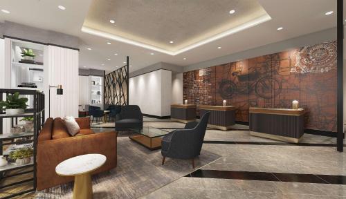 een lobby met bureaus en stoelen en een fiets aan de muur bij Hilton Woking in Woking