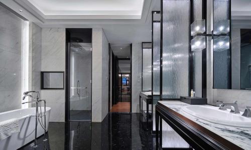 a bathroom with two sinks and two mirrors at Hilton Beijing Daxing in Beijing