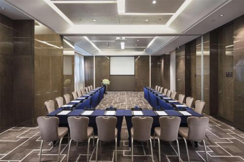 a conference room with a long table and chairs at Hilton Guangzhou Tianhe - Free Shuttle Bus and Registration Counter Available during Canton Fair Period in Guangzhou