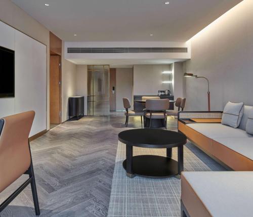 a hotel room with a couch and a table at Hilton Guangzhou Science City, Free Shuttle Bus during Canton Fair in Guangzhou
